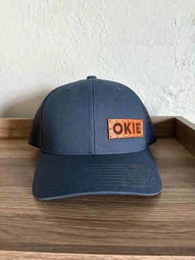 The Classic Navy Trucker Hat with Leather 'OKIE' Patch